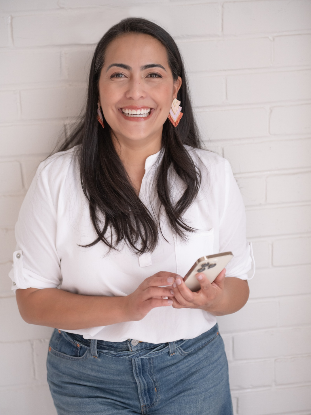 Cristina Uribe sonriendo con su celular